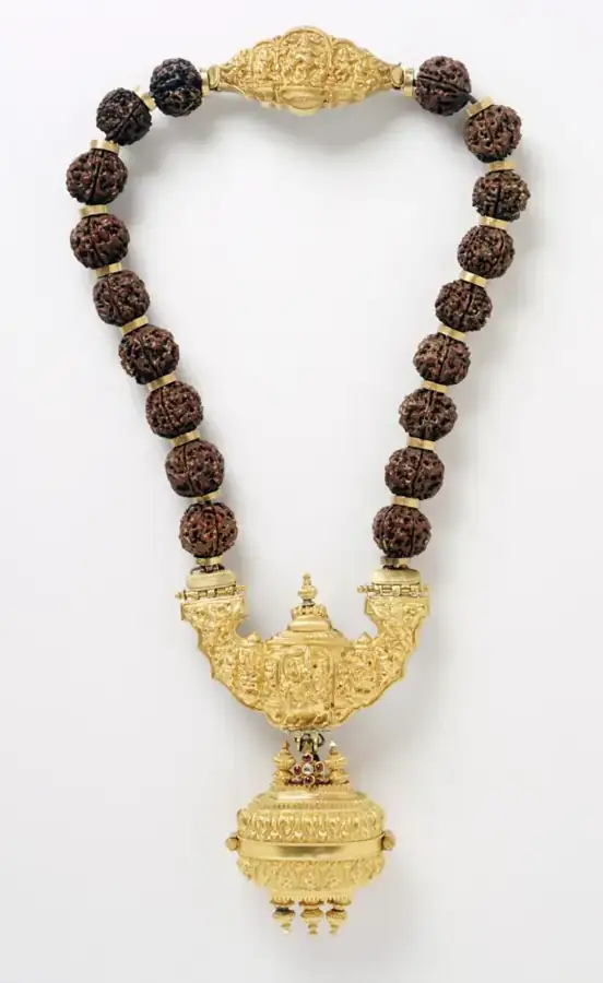 A museum necklace depicting Shiva’s family, used as a historical illustration