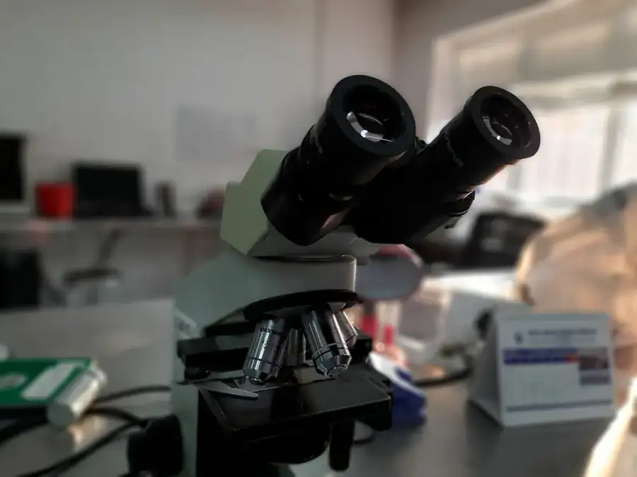 An illustrative laboratory microscope; this is not a photograph of GJSPC facilities