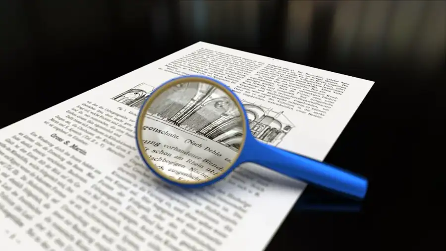 A magnifying glass positioned over printed text, illustrating document checking