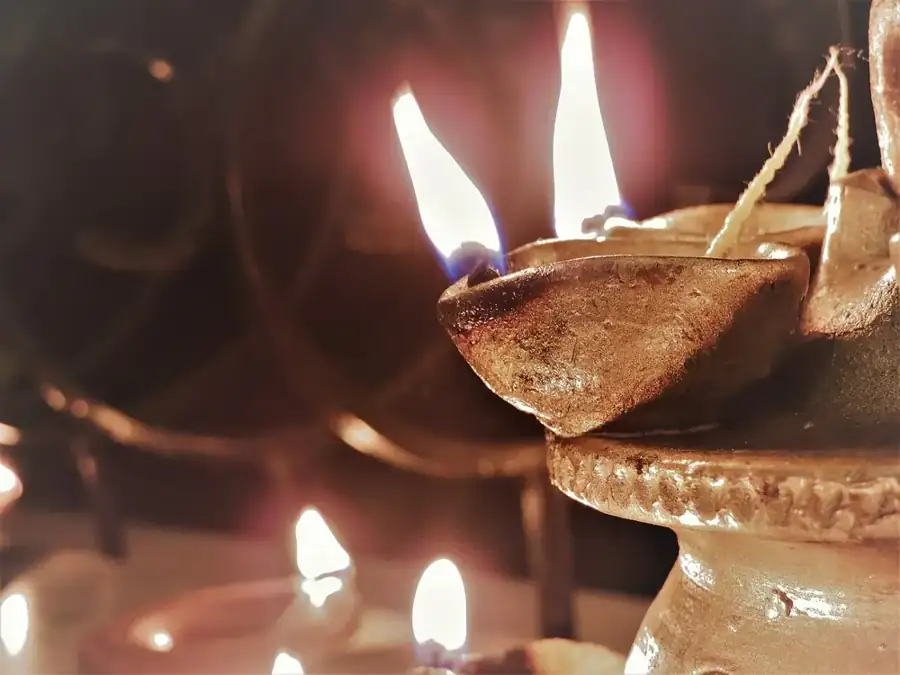 Traditional oil lamps glowing in warm ceremonial light